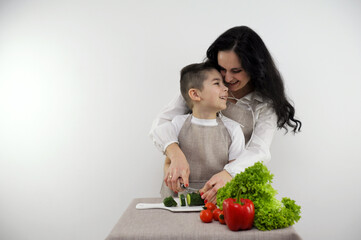 family relationships father at work mom and son cook dinner at home mom teaches son to cut...