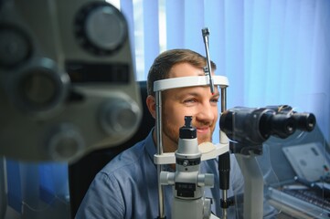 Ophthalmology concept. Male patient under eye vision examination in eyesight ophthalmological...