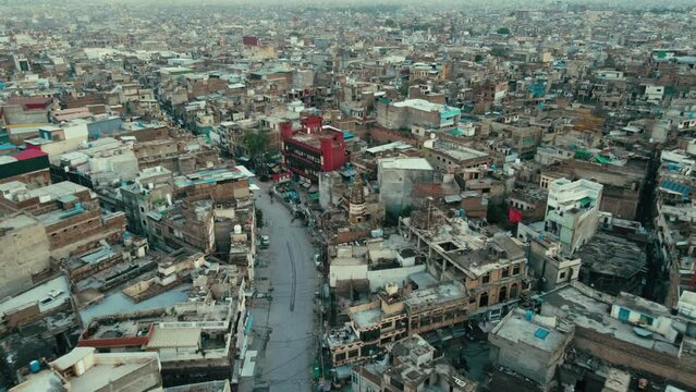 Top View Of Cityscape With historic Laal Haveli and an abandoned pre-independence Hindu temple located in Rawalpindi Punjab Province, Pakistan. - Zoom In Aerial shot