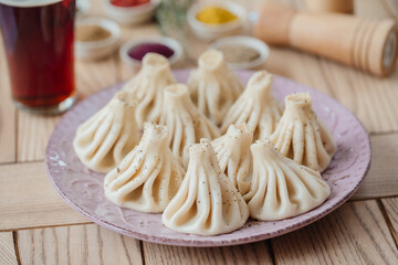 National Georgian cuisine. Khinkali with meat. Khinkali on a wooden board close-up.