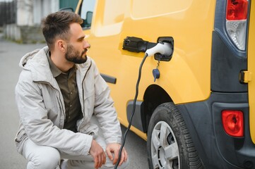 Man charging his electric car.