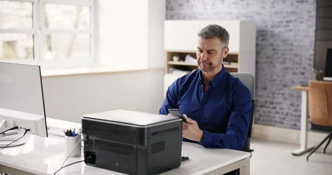 Businessman Giving Print Command On Smart Phone
