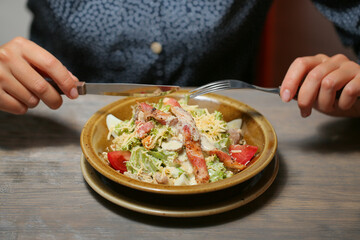 caesar salad on a white plate with sauce
