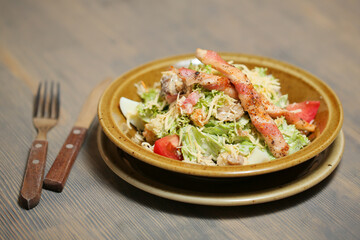 caesar salad on a white plate with sauce