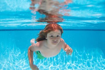 Underwater boy in the swimming pool. Cute kid boy swimming in pool under water. Summer vacation concept.