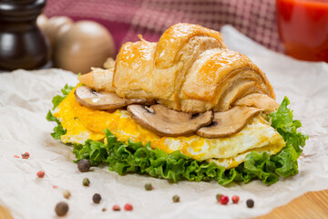 croissant with mushrooms and scrambled eggs