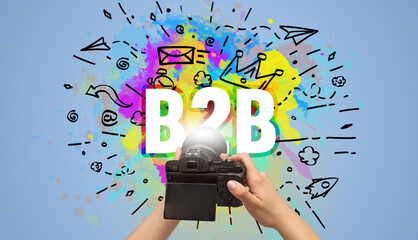Close-up of a hand holding digital camera with abstract drawing