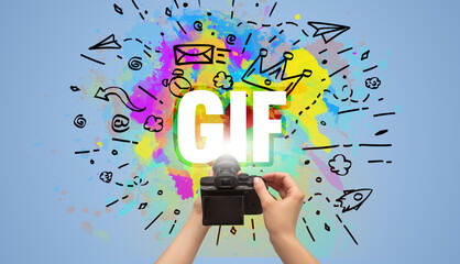 Close-up of a hand holding digital camera with abstract drawing