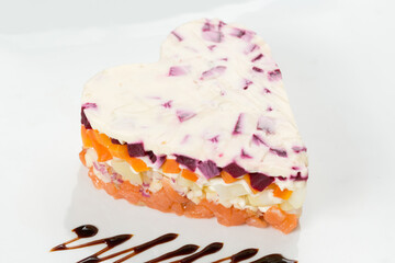 salad on a white plate in the shape of a heart