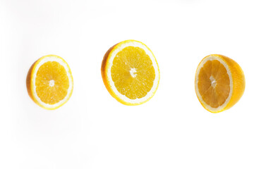 Three circles of lemon on a white background levitate