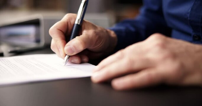 Businessman Holding Pen To Sign