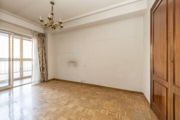 Empty living room of a house with access to a terrace closed with aluminum and glass, built-in...