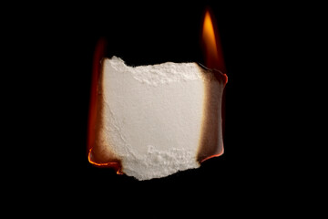 burning paper, glowing edge of paper on a black background