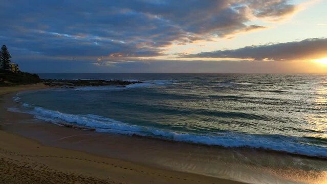 Sunrise seascape with clouds at Blue Bay on the Central Coast of NSW, Australia.