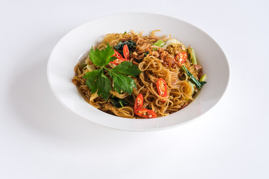 bihun goreng or stir fried rice vermicelli with vegetables and chili. a  food with delicious, spicy and sweet taste 