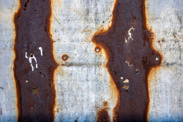 Rust and metal on an abandoned building wall