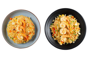 Fried rice with vegetables and seafood prawns, carrots, eggs, and tomatoes. Chinese Thai food is served on blue and black plates isolated in the background. Top view - clipping path