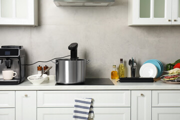 Pot with sous vide cooker in kitchen. Thermal immersion circulator