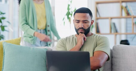Laptop, remote work and stress, black man on sofa working on freelance project for home finance or budget. Anxiety, debt and fintech, freelancer in living room checking bills and banking email online