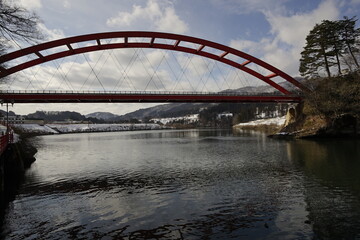 Fototapeta na wymiar the bridge over the snow river