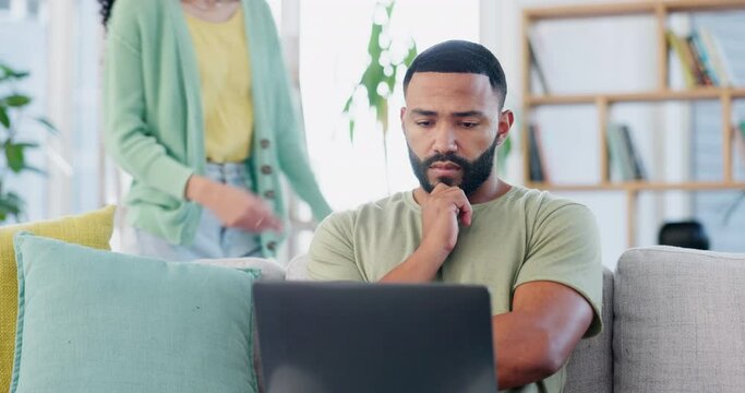 Laptop, remote work and stress, black man on sofa working on freelance project for home finance or budget. Anxiety, debt and fintech, freelancer in living room checking bills and banking email online