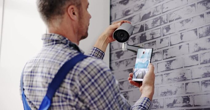 Technician Adjusting CCTV