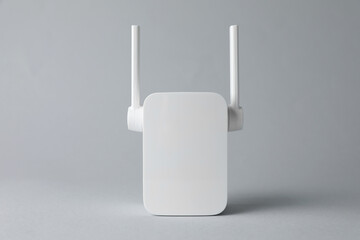New modern Wi-Fi repeater on light gray background