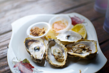 Fresh oyster in dish with lemon and lime. selectivre focus