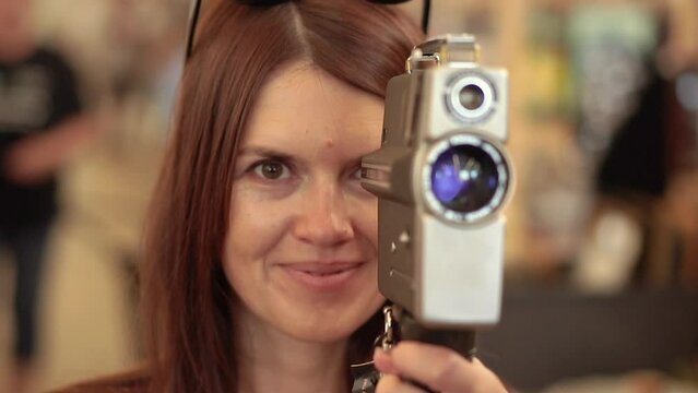 Retro camera. A woman takes pictures on a retro camera.
