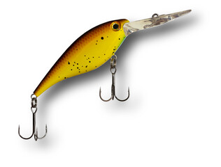 Shadow behind a Yellow and brown artificial fishing lure with two treble hooks