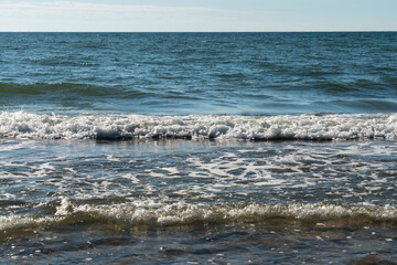 View of the incoming wave on the Baltic Sea on the shore of the Curonian Spit on a summer day, Kaliningrad region, Russia