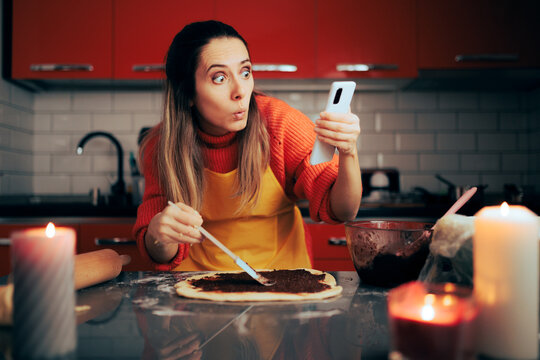 Woman Checking Online Recipe and Cooking Simultaneously. Housewife following step by step instructions for making a homemade desert