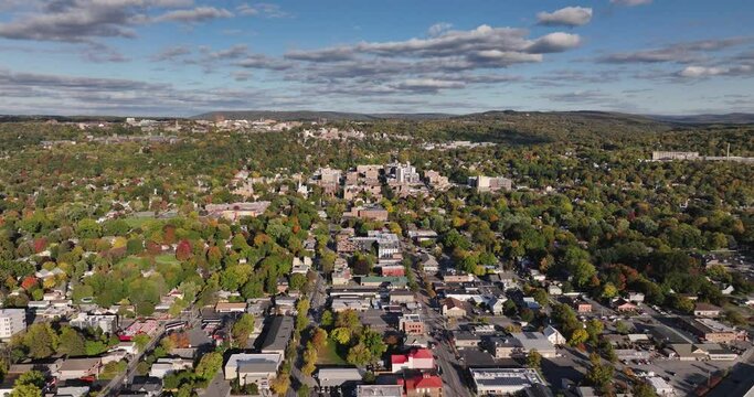 Early afternoon autumn aerial video of Ithaca New York with view east toward the downtown area.	