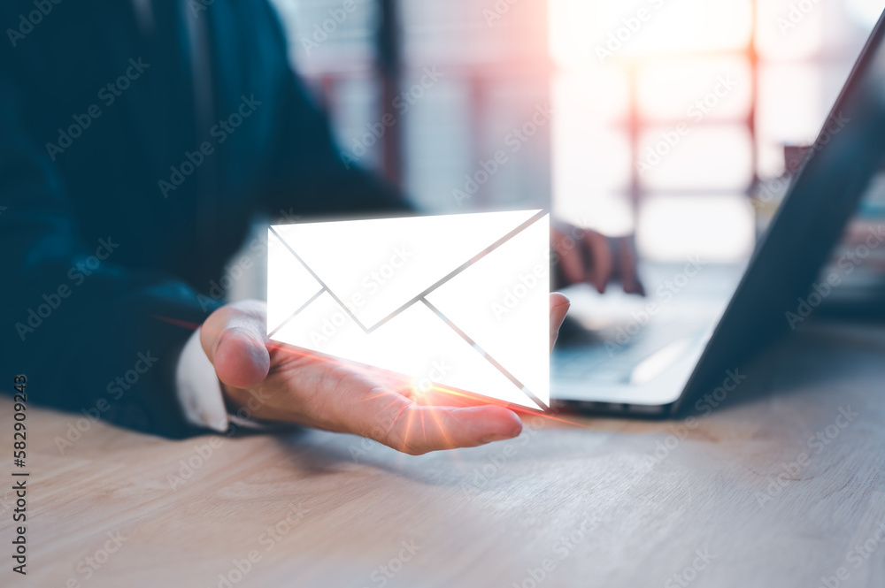 Poster email concept, businessman using computer laptop on table in office blurred background