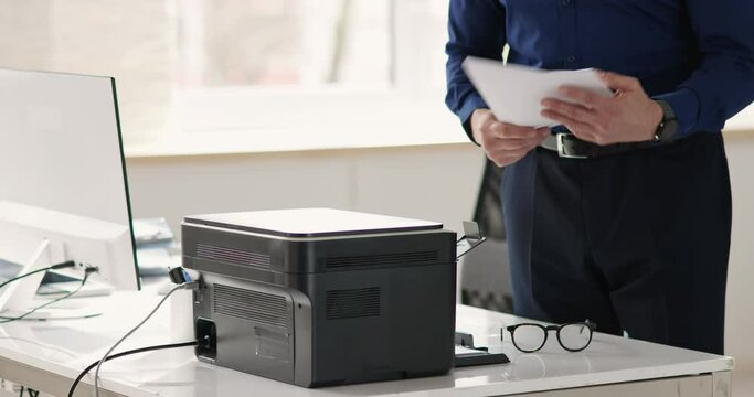 Man Using Photocopy Machine In Office