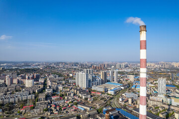 Fototapeta premium Thermal power plant chimneys in the sky of an industrial city