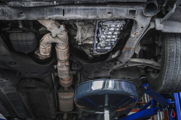 Automatic transmission service in garage shop.