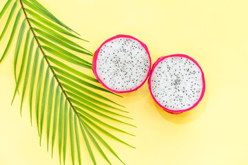 Dragon fruit, Pitaya or Pitahaya with leaf on yellow background. Top view. Flat lay