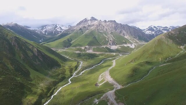 Badakhshan region of Afghanistan. Pyanj river and Pamir mountains. Pyanj is the headwaters of the Amu Darya River. Aerial view of a mountain landscape, sheep, and goats at the mouth of the river.