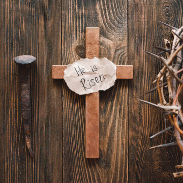 He is Risen. Jesus Crown Thorns and nails and cross on a wood background. Crucifixion Of Jesus Christ. Passion Of Jesus Christ. Concept for faith, spirituality and religion. Easter Day