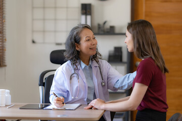 Fototapeta premium Asian female doctor doing health checkup and taking care of patient in hospital or clinic.
