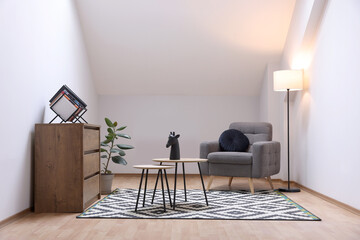 Attic room interior with slanted ceiling and furniture