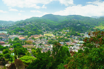 Fototapeta premium Top view of the city among the green hills. Kandy city in Sri Lanka