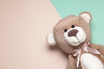 Cute teddy bear on color background, top view. Space for text