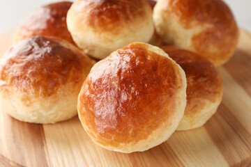 Tasty scones prepared on soda water on wooden board, closeup