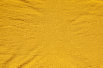 Crumpled orange fabric as background, top view