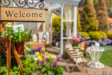 Welcome home sign in backyard garden of residential house