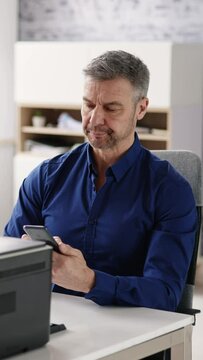 Businessman Giving Print Command On Smart Phone