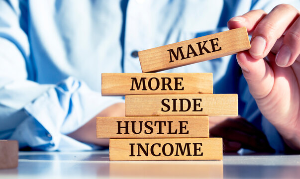 Close up on businessman holding a wooden block with "Make more side hustle income" message