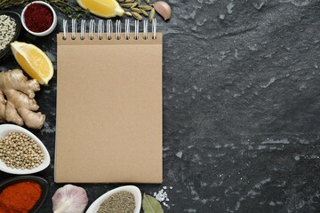 Blank recipe book and different ingredients on black textured table, flat lay. Space for text - Powered by Adobe